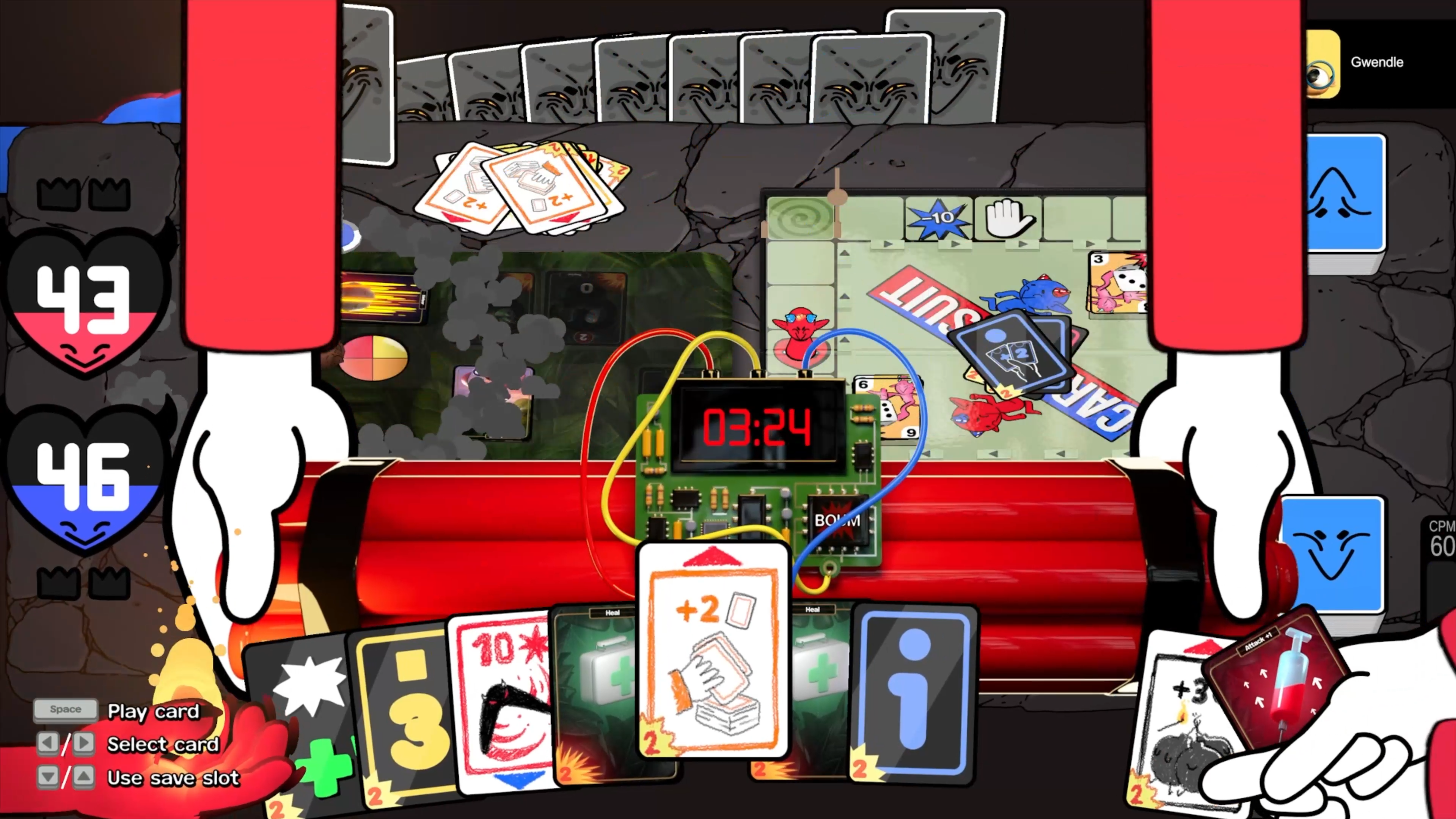 Capture d’écran de Cardburners avec une bombe à retardement au centre, des cartes en main, deux plateaux de jeu et les scores rouge et bleu des joueurs.