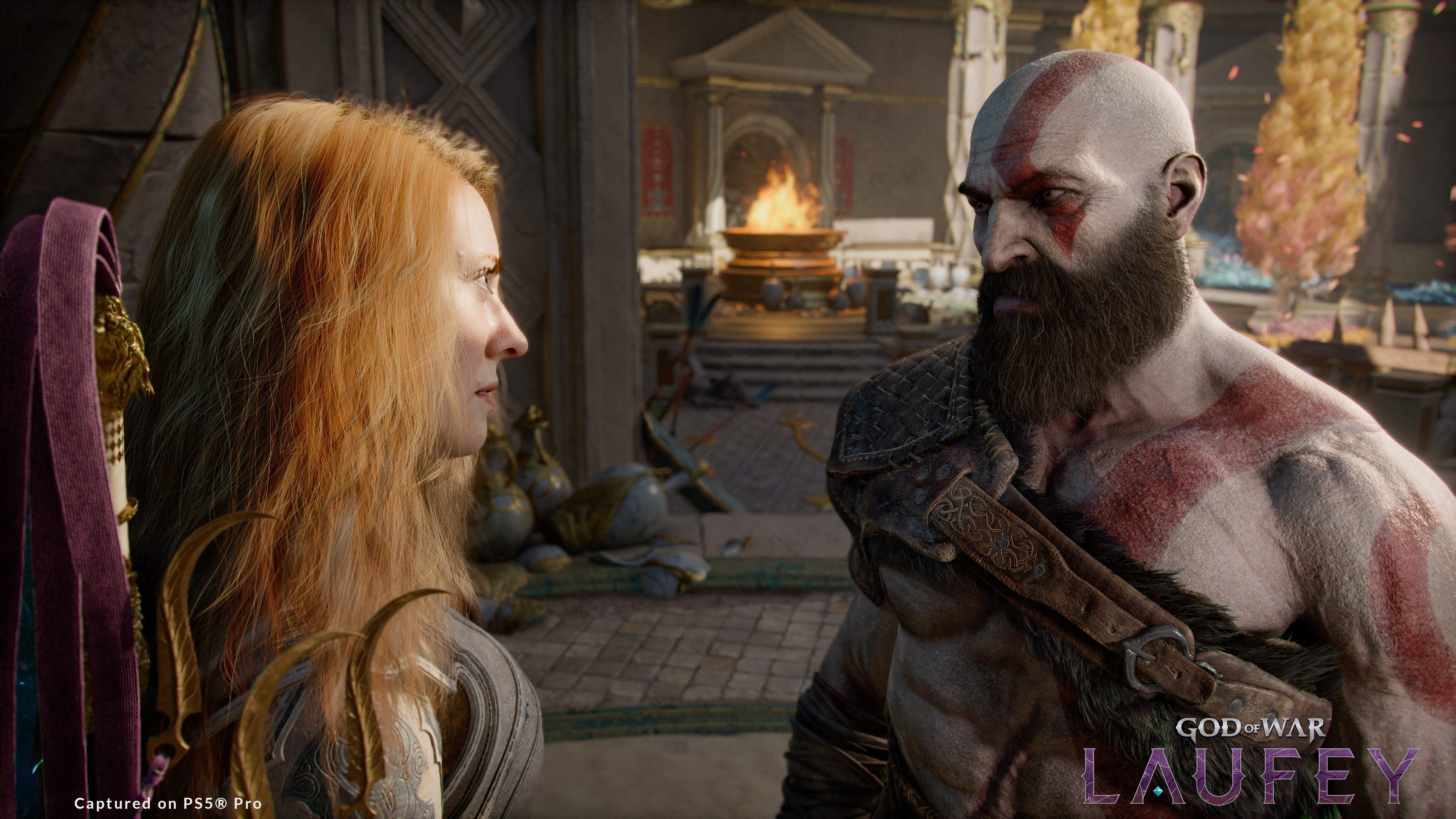 Capture de God of War: Laufey sur PS5 Pro montrant Kratos, torse nu et marqué de son tatouage rouge, face à une femme rousse en armure dans un palais endommagé. Un brasier brûle à l’arrière-plan, tandis que le logo God of War: Laufey apparaît en bas à droite.