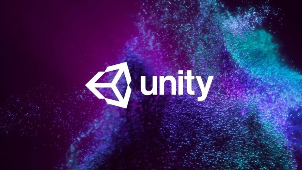 Image promotionnelle mettant en avant le logo officiel de Unity, l’un des moteurs de jeu les plus utilisés dans l’industrie vidéoludique. Le logo, de couleur blanche, est centré sur l’image et se compose du mot « unity » en lettres minuscules modernes et épaisses, accompagné à gauche de l’icône géométrique emblématique du moteur, une forme isométrique stylisée en 3D rappelant une flèche ou un cube en rotation. L’arrière-plan est un tourbillon abstrait de particules numériques aux teintes vibrantes : violet, bleu électrique, turquoise et rose, évoquant l’univers du développement numérique, de la créativité et de la simulation graphique. Ce fond dynamique donne une impression de mouvement fluide et technologique, renforçant le caractère innovant et polyvalent de Unity dans la création de jeux vidéo en 2D, 3D, réalité virtuelle (VR) ou réalité augmentée (AR). L’image transmet une identité visuelle forte, associée à la puissance graphique et à la flexibilité du moteur Unity dans le domaine du développement interactif et ludique.