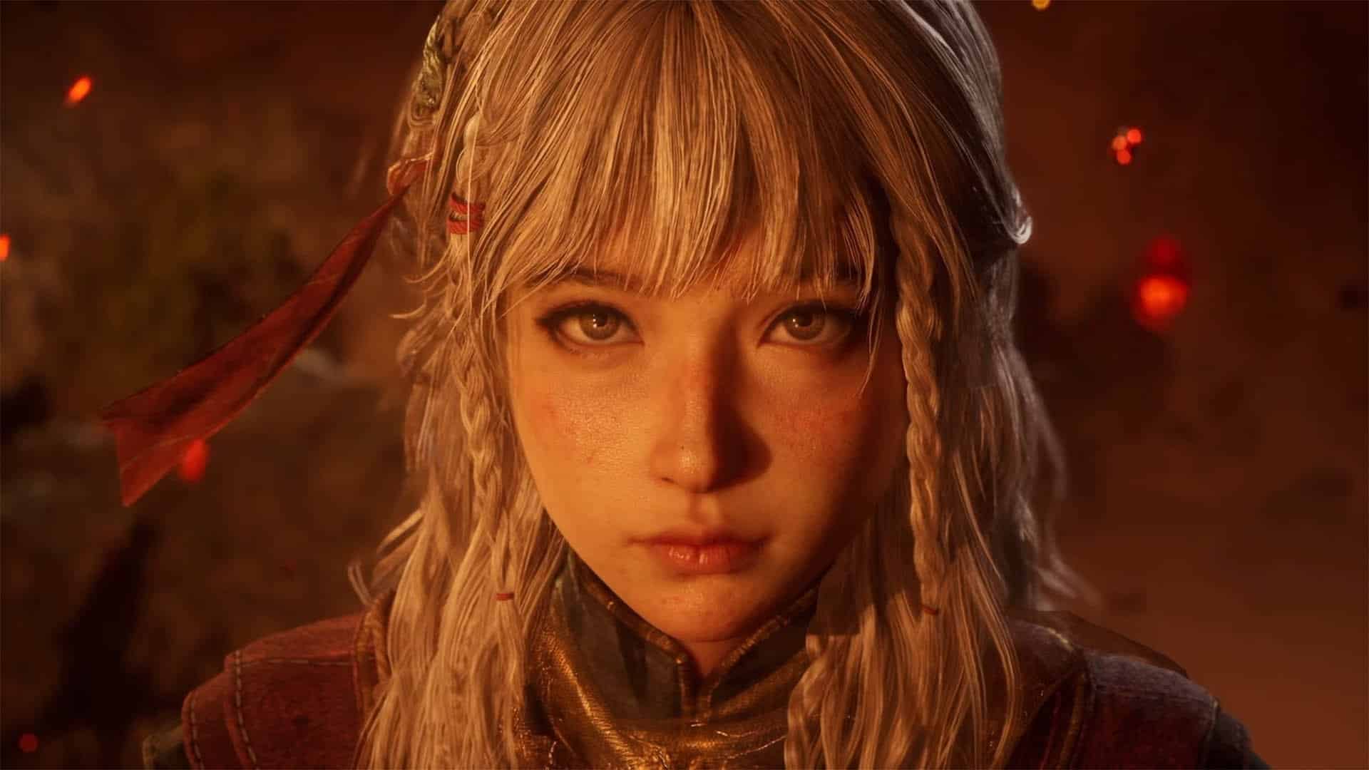 Gros plan sur une jeune femme aux longs cheveux blonds, coiffés de tresses et ornés de rubans rouges, qui fixe intensément devant elle. Son visage et son armure sont baignés d’une lumière orange, avec des braises rougeoyantes flottant dans l’arrière-plan sombre.