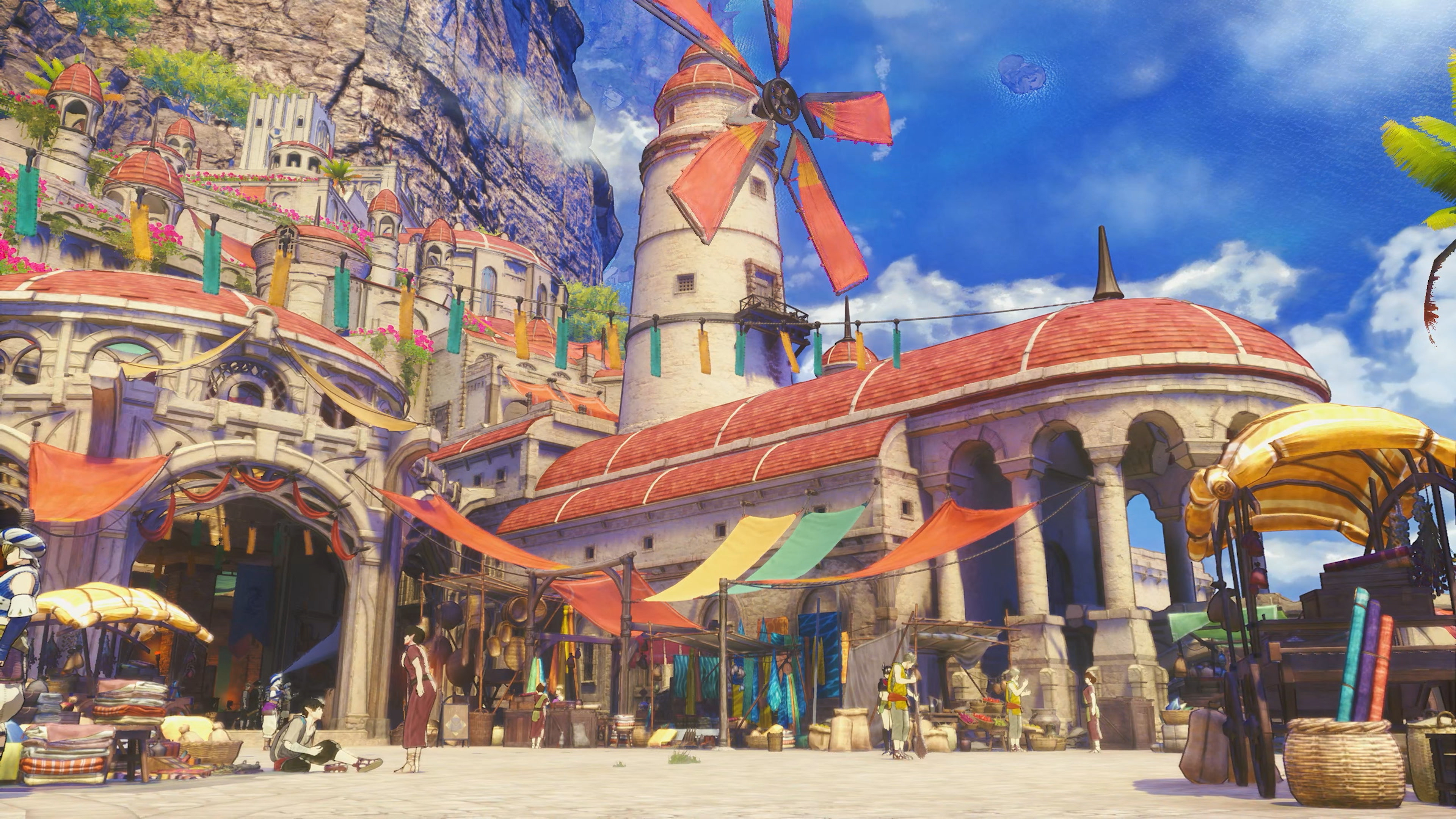 Capture d’écran d’un jeu vidéo de style JRPG montrant une ville lumineuse aux toits rouges, construite au pied de falaises sous un ciel bleu. Un grand moulin, des arches, des étals de marché colorés et plusieurs personnages donnent à la scène une ambiance vivante et méditerranéenne.