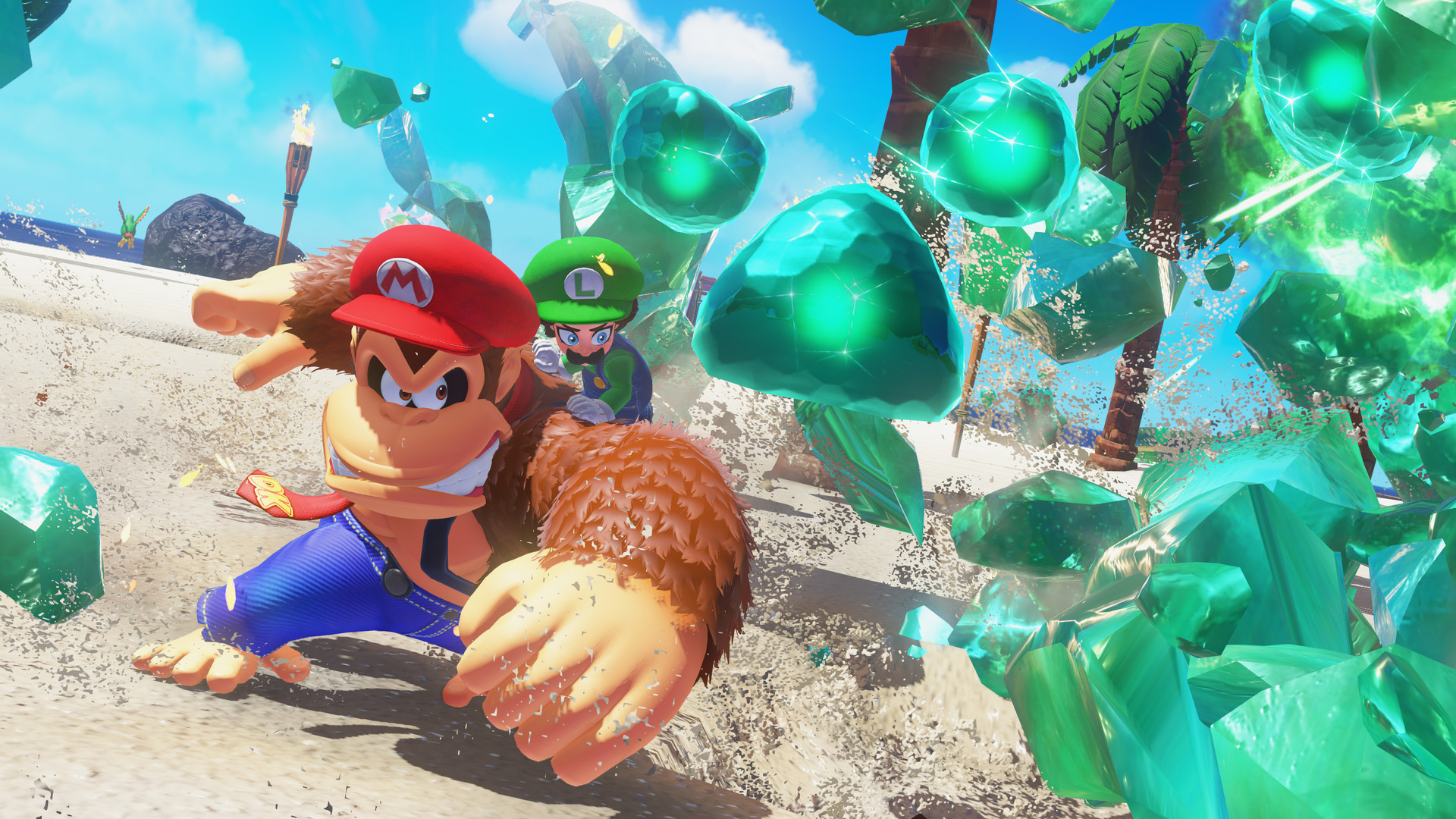 Capture d’écran de Donkey Kong Bananza montrant Donkey Kong avec une casquette rouge et une tenue bleue, fonçant sur une plage tropicale avec Luigi derrière lui. De gros cristaux verts explosent sur le côté droit de l’image, projetant du sable et renforçant l’ambiance d’action dynamique.